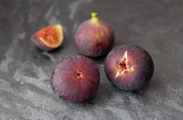 Ripe purple figs on dark background