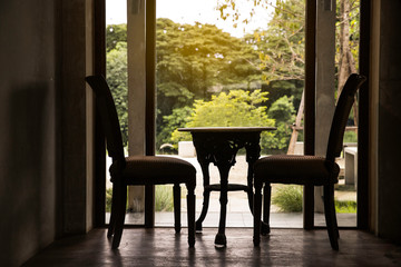 vintage style of table and chairs at the balcony garden outdoors in traditional countryside Chinese warm and cozy style house.