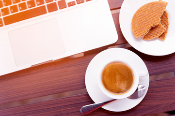 cup of coffee and laptop on table