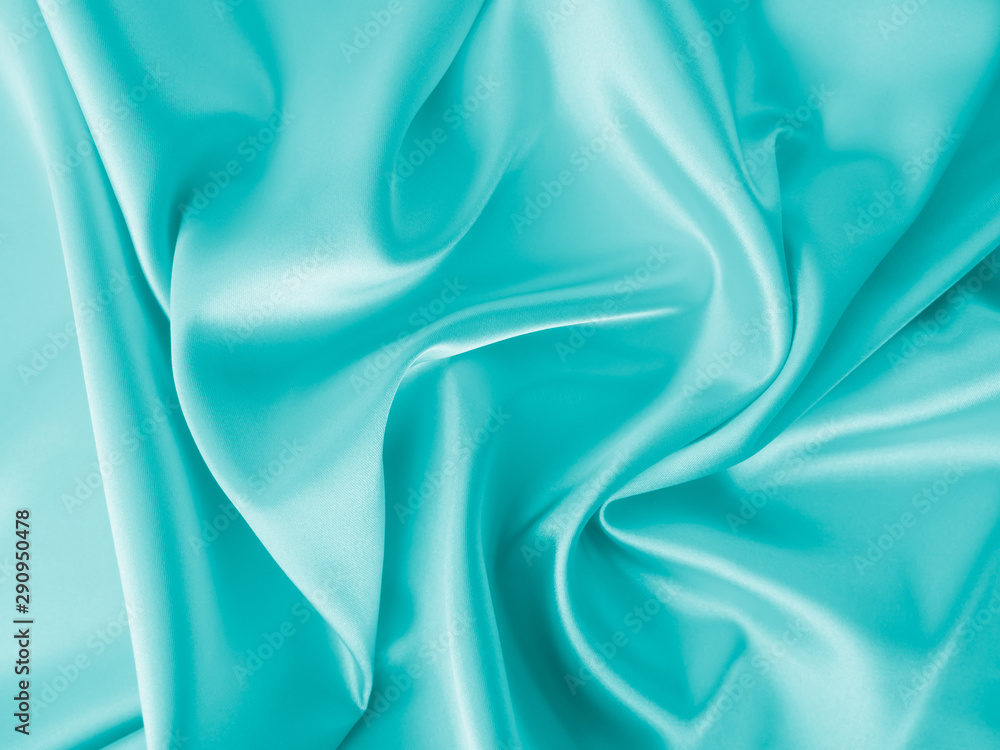 Wall mural smooth elegant wavy turquoise blue silk or satin luxury cloth fabric texture, abstract background de