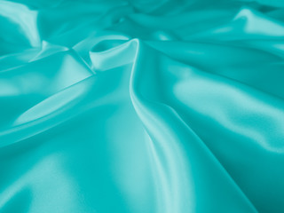 Smooth elegant wavy turquoise silk or satin luxury cloth fabric texture, abstract background design.