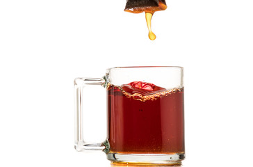 making black tea from a bag with sugar in motion on a white background