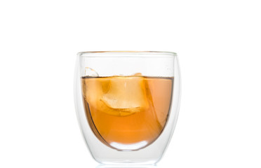 glass of whiskey with ice and a splash and spray from falling on a white background