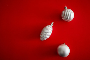 Silver  Christmas Ball on red background flat lay