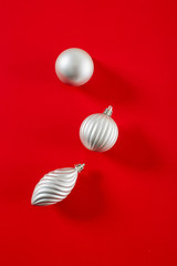 Silver  Christmas Ball on red background flat lay