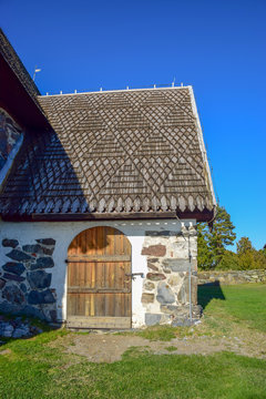 picture with very old stone house, interesting wooden tile roof