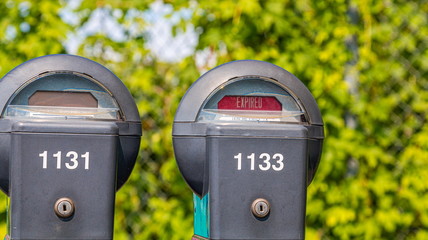 Two Expired Parking Meters on a Public Street