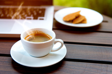 cup of tea with waffle on wooden table