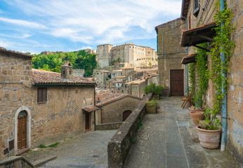 Fototapeta na wymiar Sorano (Italy) - An ancient medieval hill town hanging from a tuff stone in province of Grosseto, Tuscany region, know as the Little Matera.