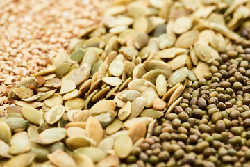 close up view of raw pumpkin seeds near maash and green buckwheat