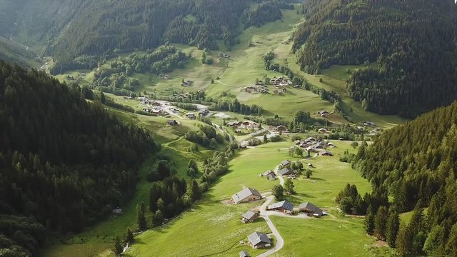 Aerial tracking shot of mountain valley village in France