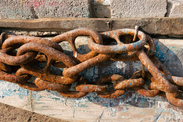 Old Rusted Chain on Weathered Wood