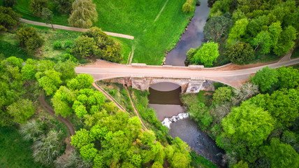 Aerial view of an old arch bridge across a river