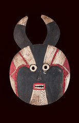 Goli female mask from Ivory Coast, Africa, carved in wood  isolated on black