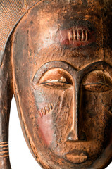 Fototapeta na wymiar Closeup of an African ceremonial mask in the form of a female figure carved in wood isolated on white.