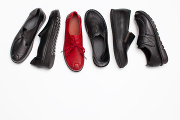 Set of autumn black shoes and one red on white background