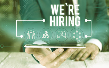 Word writing text We Re Hiring. Business photo showcasing Advertising Employment Workforce Placement New Job Male human wear formal work suit presenting presentation using smart device