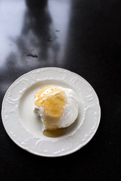 Fluffy Meringue with Golden Honey Drizzle on White Plate