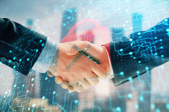 Double exposure of lock icon hologram on city view background with two people handshake. Concept of safe business
