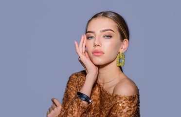 Beautiful girl with clean fresh skin. Sensual woman with fashion make-up. Beauty and fashion. Beauty, cosmetology and spa. Woman with jewelry. Beauty, stylish accessories. Fashion wear. Beauty trends.