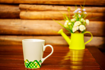 Coffee cup on wooden table background
