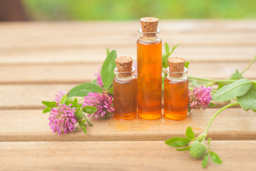 Essence of flowers on table in beautiful glass jar