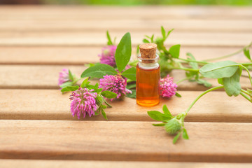 Essence of flowers on table in beautiful glass jar