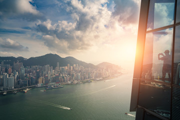 Tourists enjoying Hong Kong city views from the Sky 100 Observation Deck in West Kowloon at Hong...