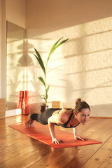 Athletic woman doing sport exercises in a studio