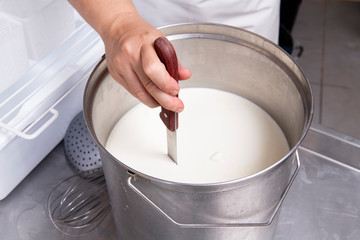 Cheesemaker cuts curdled milk