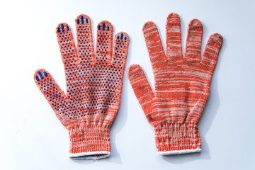 New construction gloves. knitted textile gloves on a white background. Protective equipment, safety measures. for workers, builders and installers.