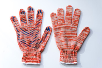 New construction gloves. knitted textile gloves on a white background. Protective equipment, safety measures. for workers, builders and installers.