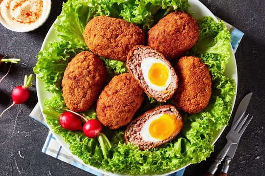 traditional fried scotch eggs on a platter