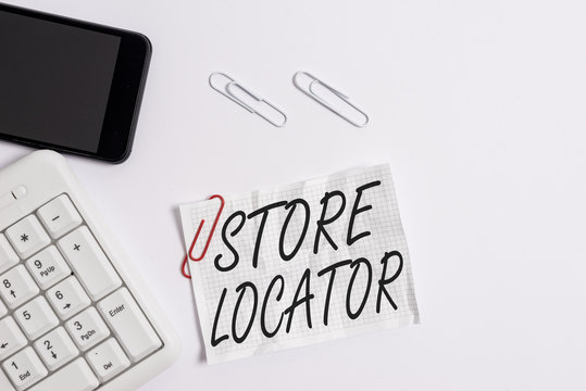 Text sign showing Store Locator. Business photo showcasing to know the address contact number and operating hours White pc keyboard with empty note paper above white background and mobile phone