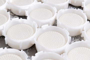 Fresh cheese just placed in plastic baskets