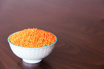 orange natural dried small lentils in a white ceramic plate