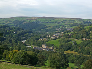 Obraz premium a panoramic view of west yorkshire countryside with trees and fields in the calder valley with the villages of luddenden and luddenden foot alongside the rochdale canal