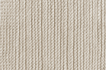 Beige knitting woolen fabric texture background