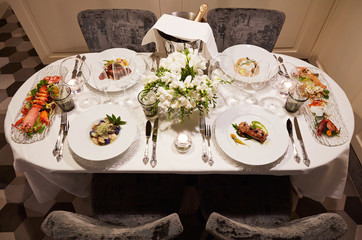 elegant dinner lobster champagne prawns cod fillet of beef clams tuna monkfish table top view flowers elegance italian cuisine italian style luxury