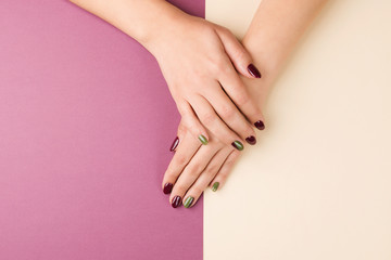 Women fashion manicure. Nails care, gel polish. Manicure, pedicure beauty salon. Beauty and fashion, top view. Stylish female manicure on color backround