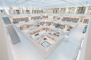 Symmetrical shot of the white interior of a moden library - obrazy, fototapety, plakaty