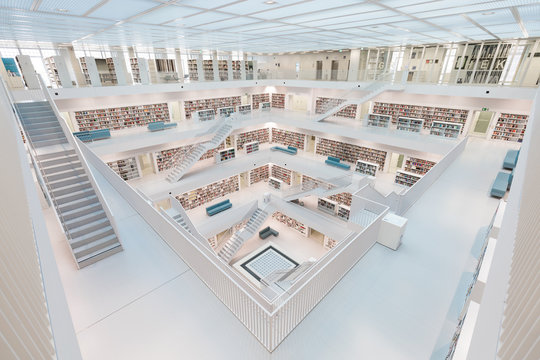Symmetrical shot of the white interior of a moden library