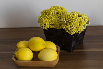 The Helichrysum Arenarium golden grass on the wooden background.