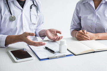 Fototapeta premium Doctor consulting with patient and checking sickness condition while presenting results diagnosis symptom examining about the problem of illness and recommend treatment method, Healthcare and medical