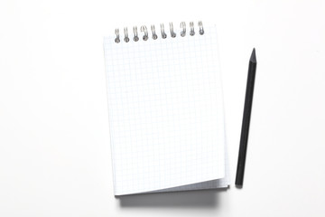 blank notepad and black pencil isolated on white background with copy space for your text
