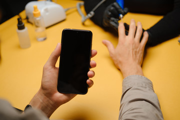 Man at beautician's during manicure