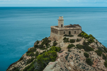 Fototapeta na wymiar Light House on Ibiza shore - Punta Grossa