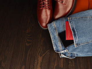 A red passport of Russia sticking from a pocket of blue denim jeans. Russian passport, Russian tourist travel concept image.