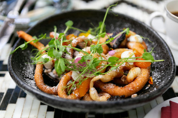 Fancy funnel cake with goat cheese, powdered sugar, edible flowers, and honey, top view, modern brunch
