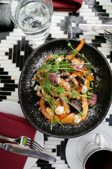 Fancy funnel cake with goat cheese, powdered sugar, edible flowers, and honey, top view, modern brunch